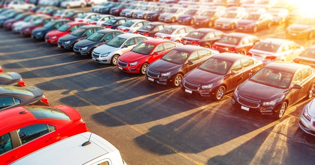 Rows of parked cars baking under the summer sun