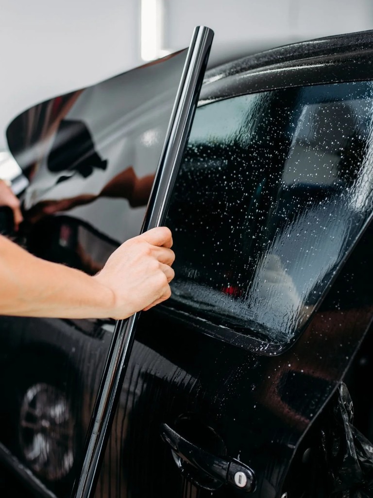 Window tint being installed on a vehicle